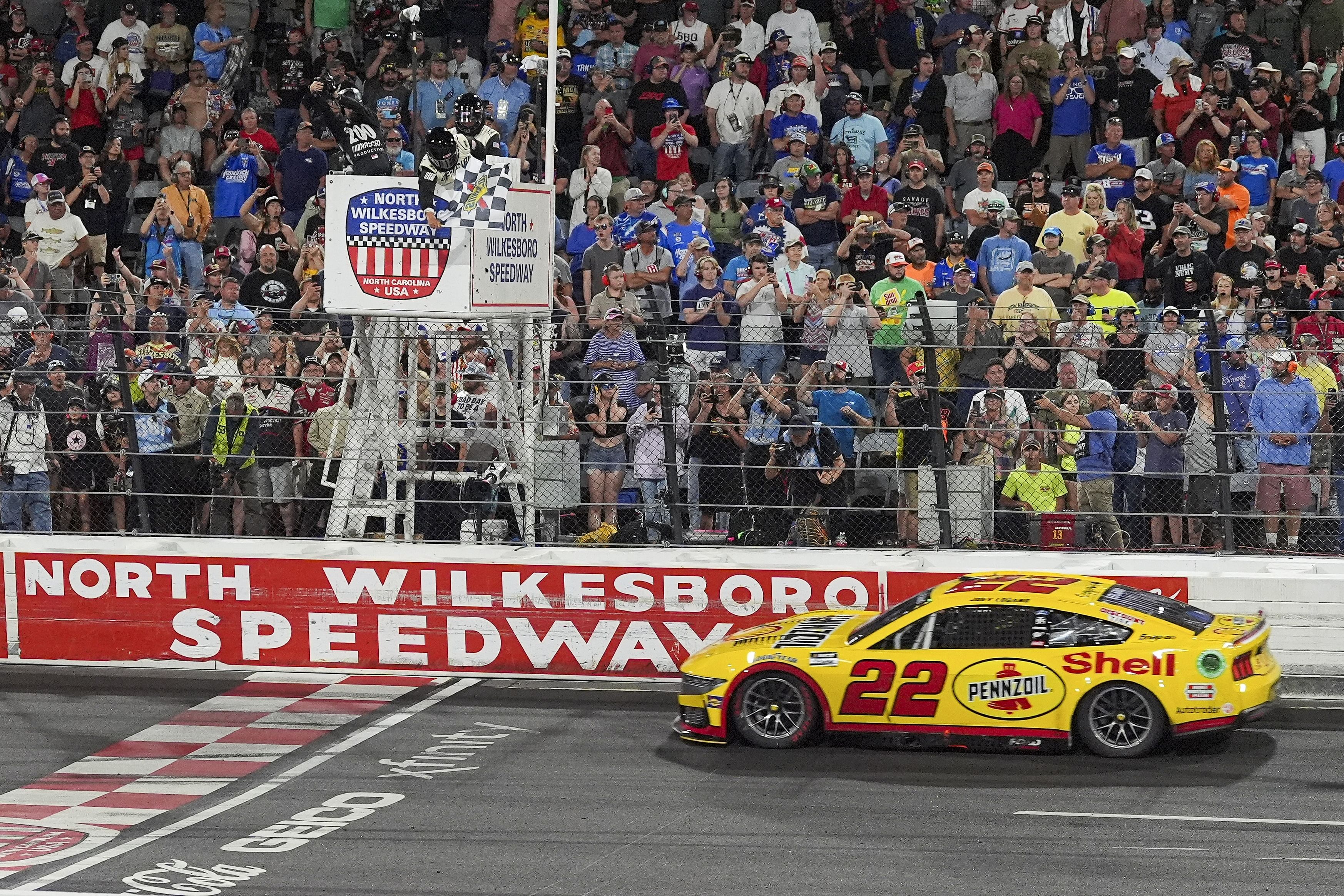 Joey Logano (22) takes the checkered flag during the 2024 NASCAR All-Star race. Source: Imagn